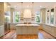 Spacious kitchen with island, marble countertops, stainless steel appliances, and hardwood floors at 515 Claret Way, Kiawah Island, SC 29455