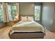 Comfortable main bedroom featuring hardwood floors, large windows, and neutral decor at 515 Claret Way, Kiawah Island, SC 29455