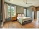 Comfortable main bedroom featuring hardwood floors, large windows, and neutral decor at 515 Claret Way, Kiawah Island, SC 29455