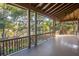 Covered outdoor porch with view of lush trees and river at 515 Claret Way, Kiawah Island, SC 29455