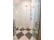 Modern shower featuring glass enclosure, bronze shower fixtures, and black and white patterned tile at 515 Claret Way, Kiawah Island, SC 29455