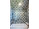 Modern tiled shower with rainfall showerhead, built-in niche, and a clean, minimalist design at 515 Claret Way, Kiawah Island, SC 29455