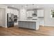 Modern kitchen with stainless steel appliances, gray cabinets, a center island, and hardwood floors at 5182 Stono Plantation Rd Dr, Hollywood, SC 29449