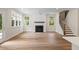 Inviting living room with fireplace, hardwood floors, large windows, and a staircase at 5182 Stono Plantation Rd Dr, Hollywood, SC 29449
