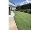 Spacious backyard with green lawn, manicured landscaping, and seating area for outdoor enjoyment at 525 Scholar Way, Summerville, SC 29486