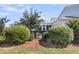 Backyard with a charming wooden gate, lush greenery, and view of sunroom, perfect for outdoor relaxation at 525 Scholar Way, Summerville, SC 29486