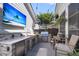 Backyard outdoor kitchen area with a stainless steel grill, sink, and outdoor seating at 525 Scholar Way, Summerville, SC 29486
