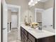 Spacious bathroom with double sinks, dark cabinets, and white countertops at 525 Scholar Way, Summerville, SC 29486