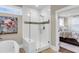 Bathroom with a glass-enclosed shower, large soaking tub, and a view to the bedroom at 525 Scholar Way, Summerville, SC 29486