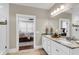 Bathroom featuring a double vanity with marble countertops, with a view into the bedroom at 525 Scholar Way, Summerville, SC 29486