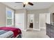 Bedroom with ceiling fan, closet, adjacent bathroom, and furniture with a dark finish at 525 Scholar Way, Summerville, SC 29486