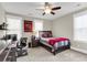 Cozy bedroom with a ceiling fan, desk area, and natural light from two large windows at 525 Scholar Way, Summerville, SC 29486