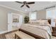 Relaxing primary bedroom featuring plush bedding and a view into the ensuite bathroom at 525 Scholar Way, Summerville, SC 29486