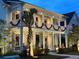Charming two-story home adorned with holiday decorations and illuminated landscaping at twilight at 525 Scholar Way, Summerville, SC 29486