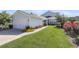 Well-maintained home exterior with a lush green lawn and colorful flowerbeds at 525 Scholar Way, Summerville, SC 29486