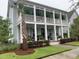 Charming two-story home with a spacious porch, well-manicured lawn and beautiful landscaping at 525 Scholar Way, Summerville, SC 29486