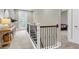 Bright hallway features a console table, access to the outside, and an ornate staircase with iron spindles at 525 Scholar Way, Summerville, SC 29486