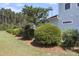 Home exterior featuring manicured landscaping, lush shrubbery, and fresh mulch, enhancing curb appeal at 525 Scholar Way, Summerville, SC 29486