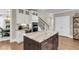 Kitchen island with granite counters, white cabinets and view into the dining room at 525 Scholar Way, Summerville, SC 29486