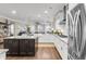 Open-concept kitchen with island, stainless appliances, and adjacent living area at 525 Scholar Way, Summerville, SC 29486