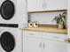 Convenient laundry room with stacked washer and dryer and butcher block countertops at 525 Scholar Way, Summerville, SC 29486