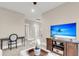 Relaxing living room with TV, side table, and view of a second hallway with bright white doors at 525 Scholar Way, Summerville, SC 29486