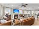 Open-concept living room featuring a fireplace, a leather sofa, and seamless access to the kitchen at 525 Scholar Way, Summerville, SC 29486
