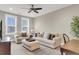 Inviting living room with plush seating, ceiling fan, neutral color palette, and great natural light at 525 Scholar Way, Summerville, SC 29486