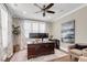 Bright home office featuring a dark wood desk, neutral walls, large windows, and modern furnishings at 525 Scholar Way, Summerville, SC 29486