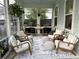Cozy screened in patio with comfortable seating, natural light, and peaceful views at 525 Scholar Way, Summerville, SC 29486