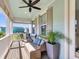 Covered front porch with comfortable seating, ceiling fan, and open view at 525 Scholar Way, Summerville, SC 29486