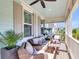 Relaxing covered porch with ceiling fan, comfortable seating, and an open view to the outside at 525 Scholar Way, Summerville, SC 29486