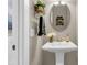 Stylish powder room featuring a pedestal sink, decorative mirror, and contemporary fixtures at 525 Scholar Way, Summerville, SC 29486