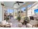 Bright sunroom featuring large windows, comfortable seating, and views of the backyard at 525 Scholar Way, Summerville, SC 29486