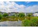 Lake view from backyard showing the well-maintained lawn and lush landscaping at 543 Mclernon Trce, Johns Island, SC 29455