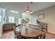 Dining area with a wooden table, views into a living room, and hardwood floors at 543 Mclernon Trce, Johns Island, SC 29455