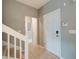 Neutral-toned hallway with white staircase and tiled floors at 543 Mclernon Trce, Johns Island, SC 29455
