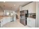 Bright kitchen featuring stainless steel appliances, white cabinets, and an open layout at 543 Mclernon Trce, Johns Island, SC 29455