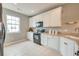 Bright kitchen featuring white cabinets, tiled floor, and modern black appliances at 543 Mclernon Trce, Johns Island, SC 29455
