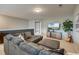 Cozy living room with plush gray sectional sofa, large-screen TV, and a decorative guitar at 543 Mclernon Trce, Johns Island, SC 29455