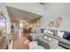 Open-concept living room with hardwood floors, a gray sectional sofa, and dining area at 543 Mclernon Trce, Johns Island, SC 29455