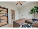A functional home office featuring a wooden desk, bookcase, neutral carpet, and access to a full bathroom at 543 Mclernon Trce, Johns Island, SC 29455