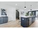 Kitchen island features navy cabinets, white countertop, pendant lights, and stainless steel faucet at 556 Scholar Way, Summerville, SC 29486