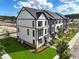 Aerial view of new townhomes showing landscaping, lawn, and surrounding community at 562 Scholar Way, Summerville, SC 29486