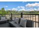 Relaxing outdoor balcony featuring comfortable seating and scenic wooded views at 562 Scholar Way, Summerville, SC 29486
