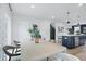 Bright dining area with a modern table setting next to the open kitchen with island at 562 Scholar Way, Summerville, SC 29486