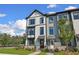 Charming townhome featuring a light gray exterior, black trim, and well-manicured landscaping at 562 Scholar Way, Summerville, SC 29486