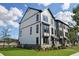 Corner view of modern townhomes, displaying their tidy lawns and unique exterior design at 562 Scholar Way, Summerville, SC 29486