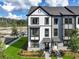 Close-up of new townhome with black framed windows, brick accents, and fresh landscaping at 562 Scholar Way, Summerville, SC 29486