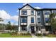 Exterior view of townhomes displaying their modern design, lawns, and well-lit doorway at 562 Scholar Way, Summerville, SC 29486